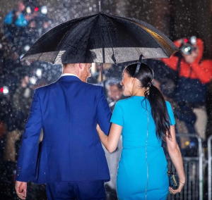 Photo of Meghan Markle and Prince Harry walking in the rain