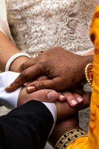 picture of marriage holding hands - Taylor Hampton assists with marriage visas